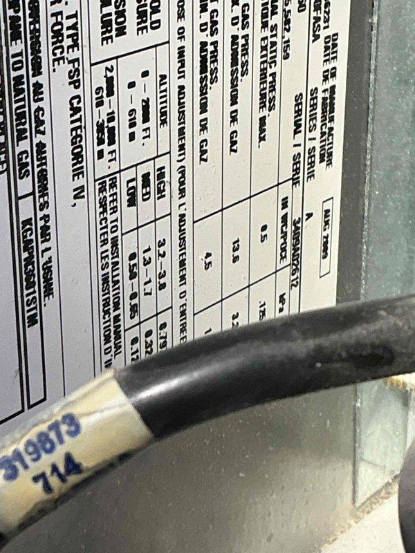 Responded to no heat call on 10+ year old furnace located in closet. Performed diagnostic evaluation and inspected unit components including rating plate and burner assembly. Identified system malfunction preventing heat operation and documented equipment specifications for service records.
