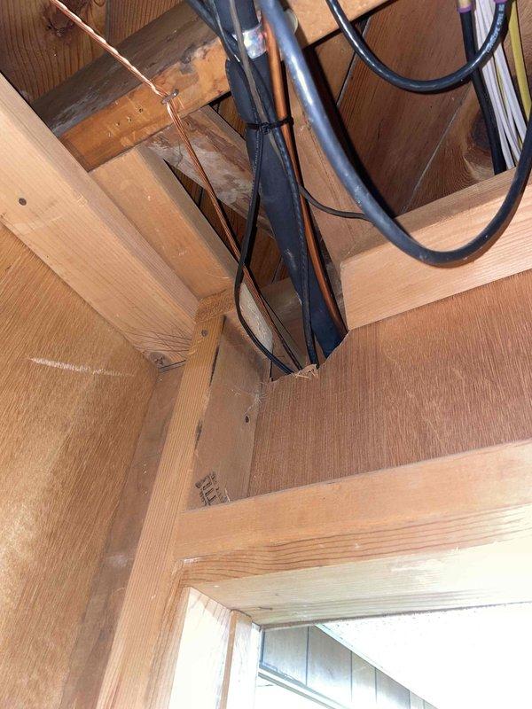 Conducted comprehensive AC system evaluation for 16-year-old unit experiencing chronic refrigerant loss requiring multiple recharges over recent years. Inspection revealed capacitor testing below manufacturer-rated microfarad specifications and visible pitting damage on contactor, indicating electrical component degradation. Assessed basement-located air handler and coil assembly, documented copper refrigerant line routing through attic framing with existing Bryant furnace system. Photographed current installation configuration including ductwork connections, electrical panel access, and refrigerant piping infrastructure to support replacement estimate preparation.