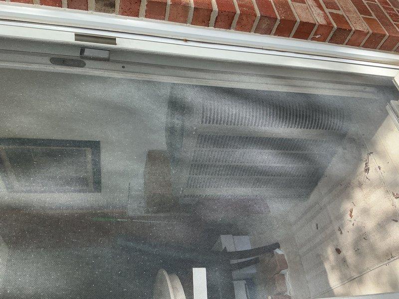 Disconnected and temporarily relocated 10-year-old air conditioning condenser unit from exterior patio location to interior dining room to accommodate customer's patio renovation project. Unit was safely dismounted from exterior wall bracket, refrigerant lines were properly capped and secured, and condenser was positioned indoors per homeowner specifications until patio reconstruction is complete.