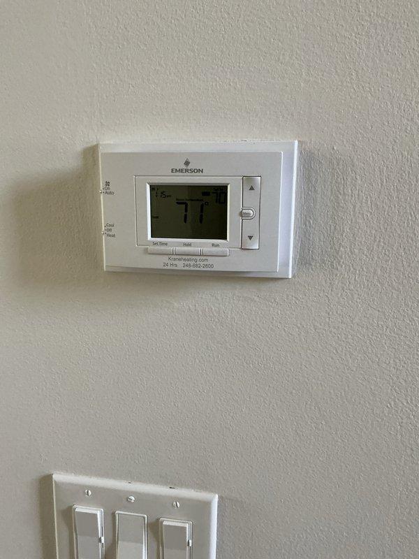 Completed comprehensive Gold AC inspection on basement-located HVAC system with Bryant equipment. Performed full system evaluation including thermostat operation verification at Emerson digital control set to 71 degrees, visual inspection of furnace unit and air handler components, assessment of ductwork connections, and examination of electrical connections at junction box. All components photographed and documented, system found operational with no immediate service requirements identified during inspection.