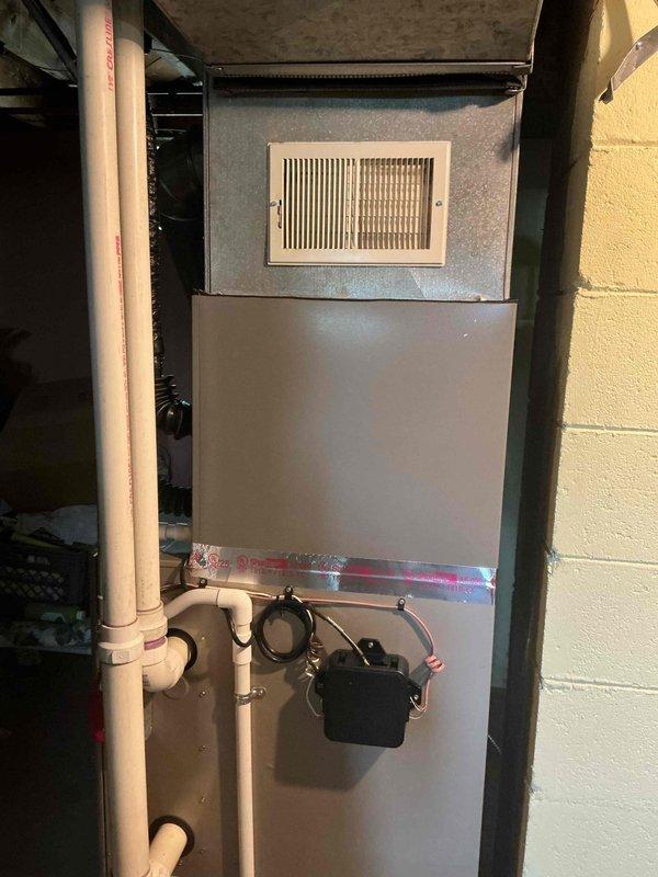 Completed full installation of 2-ton air conditioning system including outdoor Lennox condenser unit and indoor evaporator coil. Installed condenser in rear yard location on composite pad with proper gravel base, connected refrigerant lines to indoor air handler unit in basement, and completed all electrical connections. Verified proper refrigerant charge, tested system operation, and confirmed cooling functionality throughout entire system.