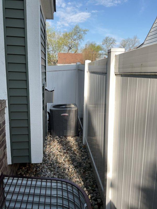 Completed installation of 3.5-ton air conditioning unit with new evaporator coil on left side of residence. System was positioned in narrow side yard area against privacy fencing on gravel base, with unit properly secured and leveled. Electrical reconnection was performed in accordance with code requirements. Mechanical and electrical permits were requested and processed for the installation. System was flushed, tested, and verified operational upon completion.