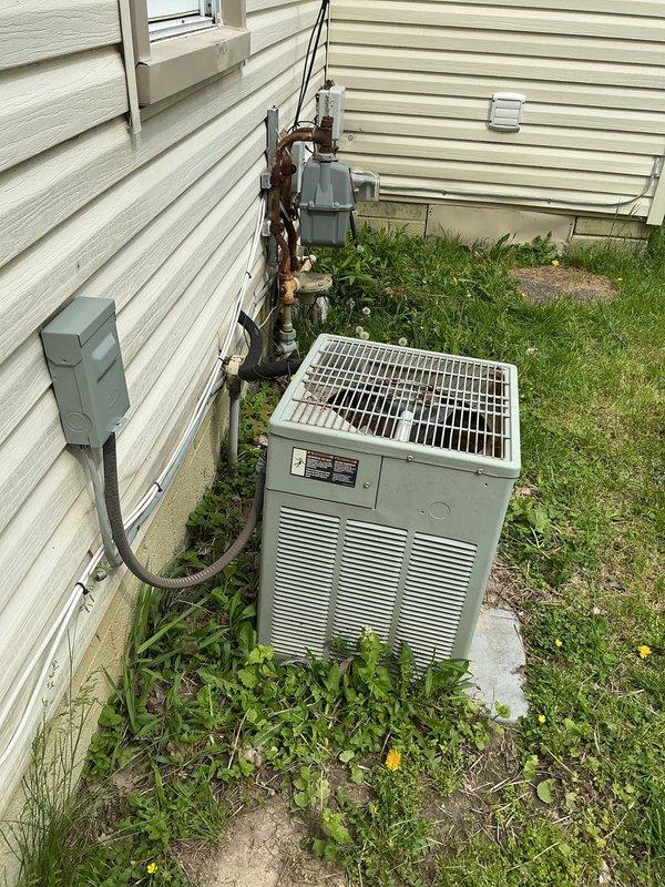Responded to service call for central air conditioning system not cooling the home. Upon inspection, found R22 refrigerant system with Ameristar air handler in interior utility closet and outdoor condenser unit. System was running but failing to provide adequate cooling. Evaluated both indoor and outdoor components, checked refrigerant levels, and assessed overall system condition. Provided comprehensive estimate for complete HVAC system replacement due to obsolete R22 refrigerant and age-related equipment concerns. Documented existing installation with photos showing indoor air handler with ductwork configuration and outdoor condenser unit on concrete pad with refrigerant lines and electrical connections.