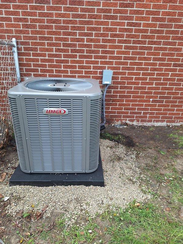 Completed installation of a 2.5-ton Lennox air conditioning condenser unit with matching evaporator coil system. The outdoor unit was positioned on the right side of the property on a protective pad against the brick exterior, with proper electrical disconnect installed and refrigerant lines run through insulated copper tubing connecting to the indoor coil assembly. All electrical connections, refrigerant line sets, and control wiring were completed per manufacturer specifications, with the system tested and operational upon completion.