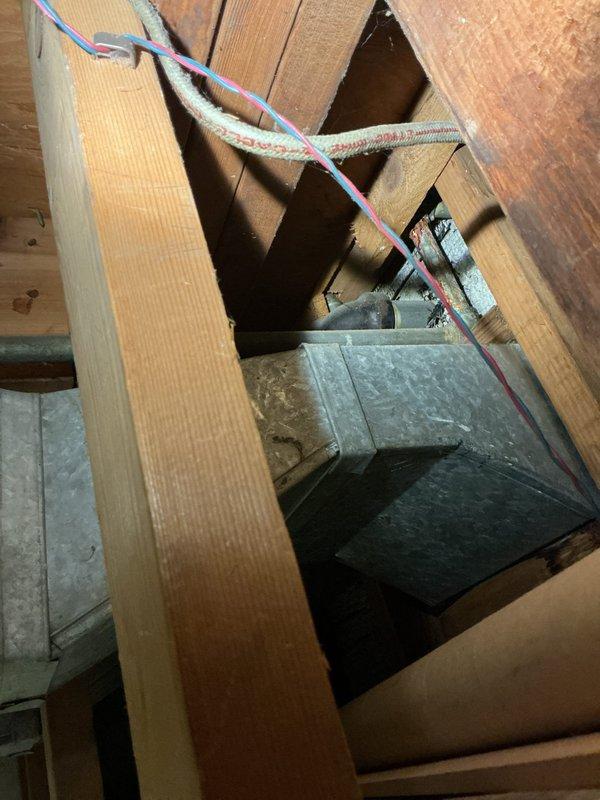 # Plumbing Repair Completed

Responded to service call for under-sink plumbing concerns. Upon inspection, discovered significant condensation accumulation on galvanized supply pipes beneath bathroom fixture, indicating potential temperature differential issues or inadequate ventilation. Photographically documented existing pipe assembly configuration, including chrome shut-off valve connections and mounting hardware. Assessed attic space above service area to identify any contributing factors, noting exposed framing, fiberglass insulation placement, and utility routing. Verified all threaded connections were secure and properly sealed. Ensured proper drainage function and confirmed no active leaks present in the supply line assembly.