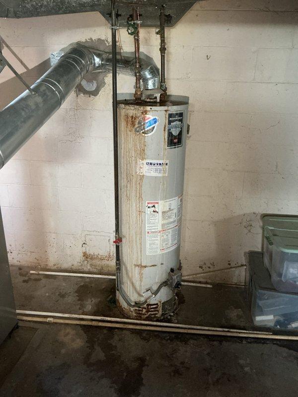 Successfully completed a 40-gallon tanked water heater replacement in a basement utility area. The original unit exhibited significant deterioration with extensive rust staining throughout the tank exterior, indicating advanced age and potential structural compromise that necessitated immediate replacement.

Removed the existing water heater and installed a new 40-gallon residential gas-fired tanked water heater. Connected all copper supply lines with proper brass fittings and installed pressure relief valve per manufacturer specifications and local code requirements. Verified all plumbing connections for proper seal and tested for leaks. Connected exhaust venting system to ensure safe combustion gas evacuation from the space.

The customer was informed that this installation does not include chimney liner or chimney cap, and these components may require additional work if determined necessary during future inspection. All connections were pressure tested and the unit was fired up to v