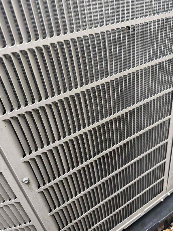 Performed routine maintenance inspection on 13-year-old Bryant residential air conditioning system with air handler located in basement. Inspected outdoor condenser unit, verified proper operation of compressor and condenser fan motor, examined condenser coil fins for damage and airflow obstruction, and removed debris from top grille and fan cover. All components operating within normal parameters at time of service.