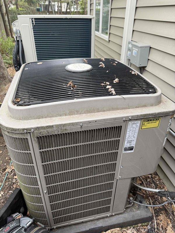 Performed routine maintenance inspection on 13-year-old Bryant residential air conditioning system with air handler located in basement. Inspected outdoor condenser unit, verified proper operation of compressor and condenser fan motor, examined condenser coil fins for damage and airflow obstruction, and removed debris from top grille and fan cover. All components operating within normal parameters at time of service.