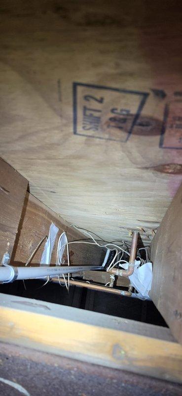 Responded to warranty call for water overflow from coil drain line onto utility room floor. Upon crawl space inspection, found sump pump disconnected with power cord on floor and reconnected pump to ceiling-mounted outlet. Discovered 3/4" PVC condensate drain line improperly secured with zip ties to lineset, creating multiple bows with inadequate pitch preventing proper drainage. Identified that approximately 30 feet of drain line requires either proper pitch correction and routing to sump pump, or installation of condensate pump with shortened 6-foot run to nearby sink for code-compliant drainage.