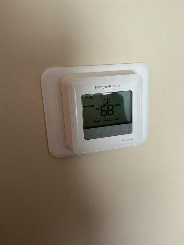 Completed comprehensive Gold AC inspection on residential Lennox air conditioning system less than one year old. Performed full system evaluation including thermostat operation verification, outdoor condensing unit assessment, electrical connections inspection, and refrigerant system check. Unit found operating within normal parameters with Honeywell ProSeries thermostat displaying proper temperature readings and responsive controls. Outdoor condenser examined for proper airflow, fan operation, and cabinet condition. All components functioning as designed with no deficiencies noted at time of inspection.