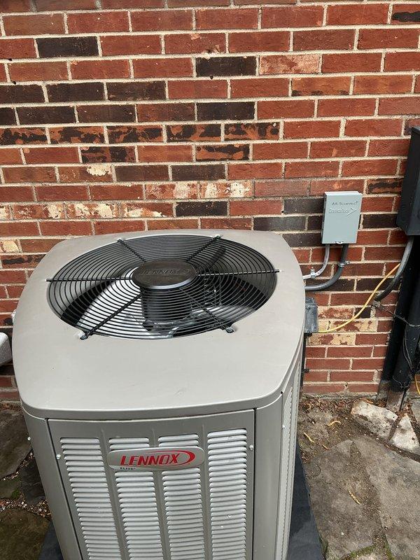 Completed comprehensive Gold AC inspection on residential Lennox air conditioning system less than one year old. Performed full system evaluation including thermostat operation verification, outdoor condensing unit assessment, electrical connections inspection, and refrigerant system check. Unit found operating within normal parameters with Honeywell ProSeries thermostat displaying proper temperature readings and responsive controls. Outdoor condenser examined for proper airflow, fan operation, and cabinet condition. All components functioning as designed with no deficiencies noted at time of inspection.