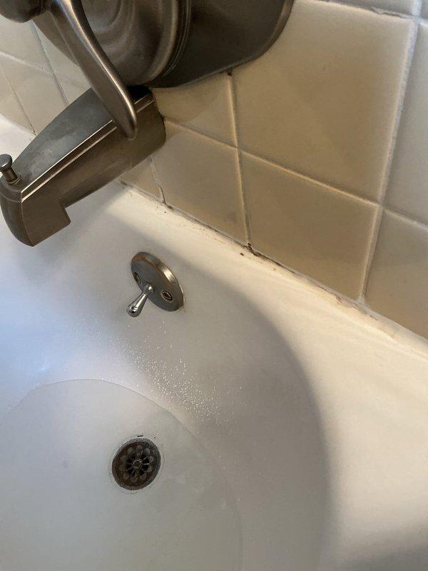 Responded to service call for completely backed up bathtub. Upon arrival, performed diagnostic inspection of tub drain system and overflow assembly. Identified blockage in drain line causing complete backup. Utilized appropriate drain clearing equipment to remove obstruction and restore proper drainage. Tested tub drain and overflow function to verify full water flow restored. Inspected wall-mounted faucet assembly, tub spout, drain cover, and overflow plate for proper operation. All fixtures functioning correctly upon completion, with no leaks detected at drain connections or overflow assembly.