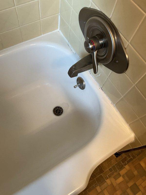 Responded to service call for completely backed up bathtub. Upon arrival, performed diagnostic inspection of tub drain system and overflow assembly. Identified blockage in drain line causing complete backup. Utilized appropriate drain clearing equipment to remove obstruction and restore proper drainage. Tested tub drain and overflow function to verify full water flow restored. Inspected wall-mounted faucet assembly, tub spout, drain cover, and overflow plate for proper operation. All fixtures functioning correctly upon completion, with no leaks detected at drain connections or overflow assembly.