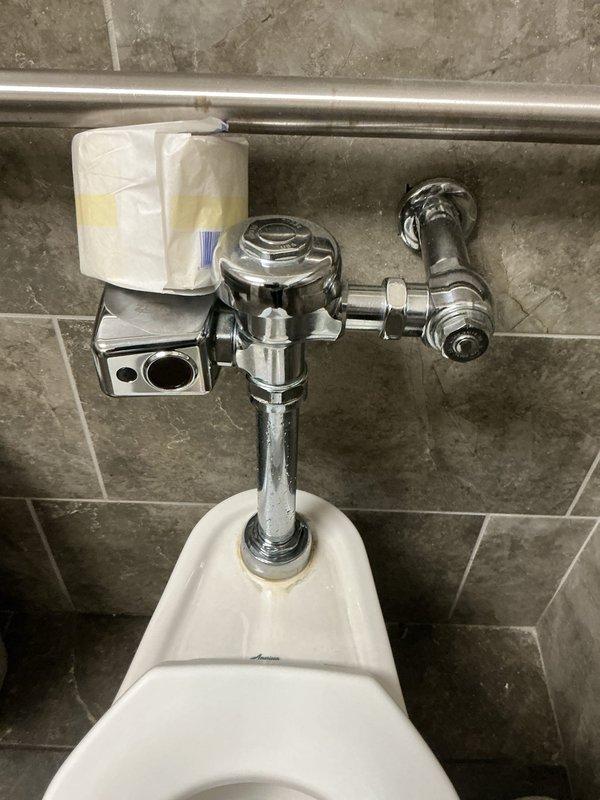 Responded to commercial men's restroom for two non-flushing toilets with leaking flush valves. Inspected both wall-mounted toilet fixtures and identified malfunctioning automatic and manual flush valve systems causing operational failures and water leakage from top valve assemblies. Repaired flush valve mechanisms, replaced faulty internal components, and tested both fixtures to restore proper flushing function and eliminate leaks. All chrome plumbing components and water supply lines verified for proper operation and leak-free performance.