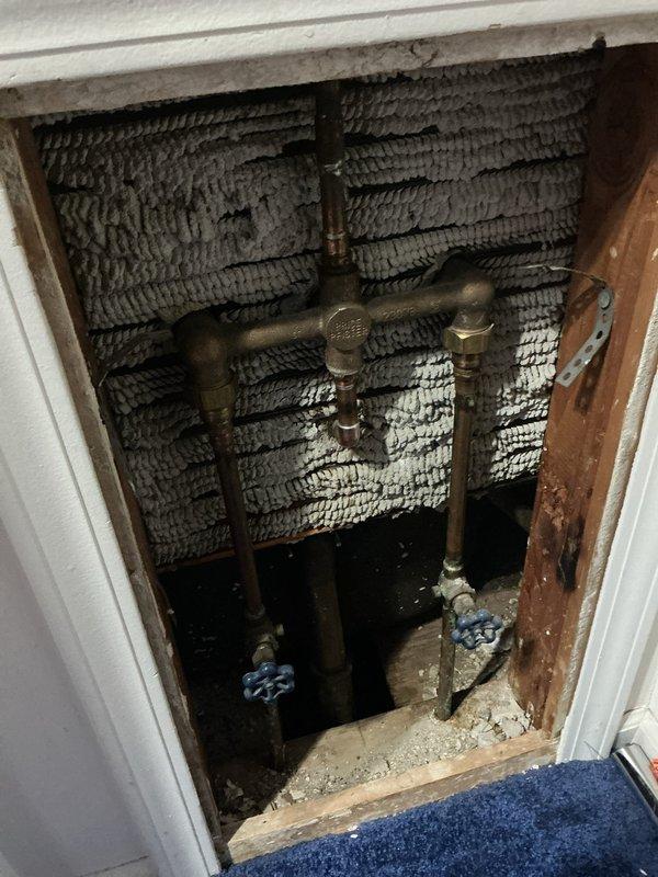Responded to intermittent leak from rarely used shower head in master bathroom of 1968-built home. Upon inspection, identified malfunctioning tub spout diverter causing water to flow simultaneously from both shower head and tub spout during shower operation. Accessed plumbing infrastructure through existing wall panel to inspect valve assembly and supply lines for potential water intrusion. Replaced defective diverter mechanism and tested system under full water pressure to confirm proper operation and complete water diversion to shower head. Verified no moisture present in wall cavity and confirmed all connections sealed properly with no active leaks detected.
