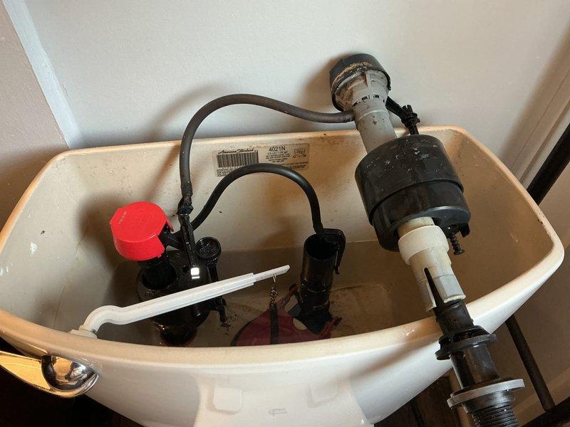 Responded to service call for leaking toilet and hot water heater concerns following municipal water work in the area. Inspected toilet tank assembly and identified faulty fill valve and flush valve components causing water leak. Replaced both fill valve assembly with new unit featuring red cap mechanism and installed new tower-style flush valve assembly to eliminate leaking condition. Verified proper water level settings, tested flush operation, and confirmed no active leaks from tank components upon completion of repairs.