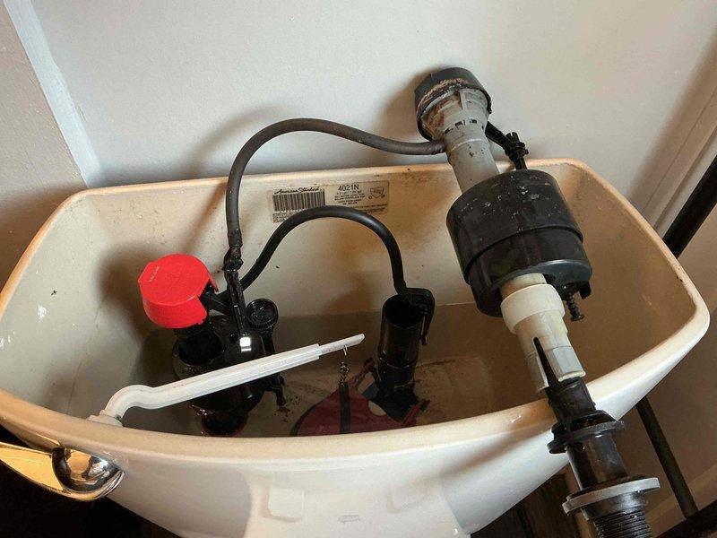Responded to service call for leaking toilet and hot water heater concerns following municipal water work in the area. Inspected toilet tank assembly and identified faulty fill valve and flush valve components causing water leak. Replaced both fill valve assembly with new unit featuring red cap mechanism and installed new tower-style flush valve assembly to eliminate leaking condition. Verified proper water level settings, tested flush operation, and confirmed no active leaks from tank components upon completion of repairs.