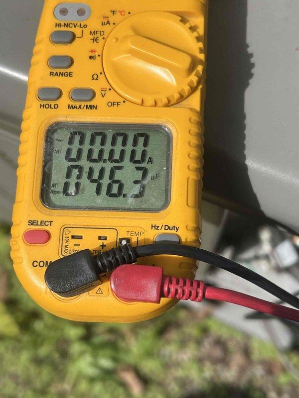 Completed comprehensive Gold AC inspection on 10+ year old single unit system with air handler located in basement. Performed electrical diagnostics using digital multimeter, measuring amperage draw at 0.000A and voltage reading of 242V, along with capacitance testing showing 846.3 MFD to verify proper compressor and fan motor operation. System found operating within normal parameters with all components functioning correctly at time of inspection.