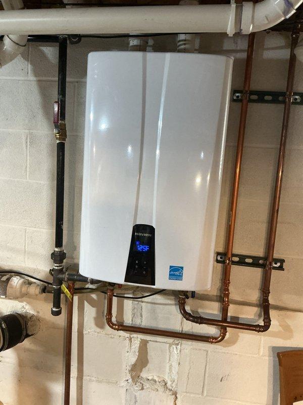 Performed annual maintenance flush on Navien tankless water heater unit located in basement. Completed descaling procedure to remove mineral buildup from heat exchanger, flushed system with cleaning solution, and verified all connections for proper operation. Unit tested and confirmed operating at 125°F setpoint with all functions working properly upon completion.