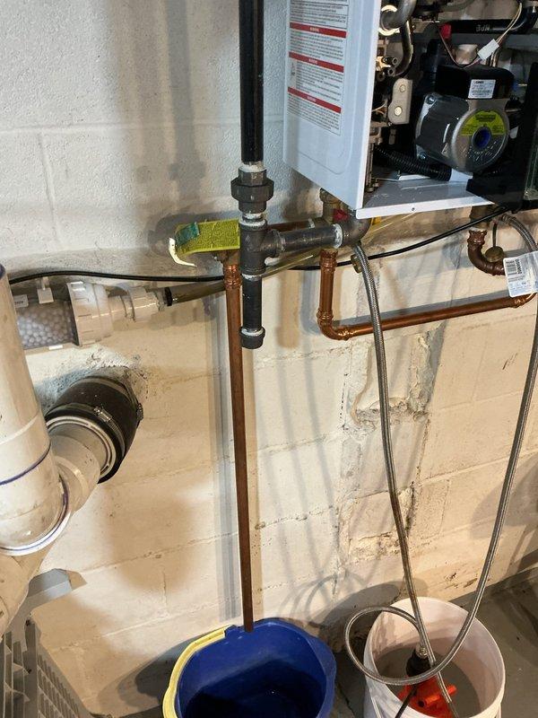 Performed annual maintenance flush on Navien tankless water heater unit located in basement. Completed descaling procedure to remove mineral buildup from heat exchanger, flushed system with cleaning solution, and verified all connections for proper operation. Unit tested and confirmed operating at 125°F setpoint with all functions working properly upon completion.