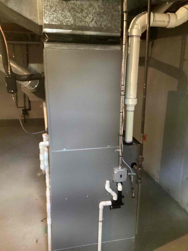 Performed comprehensive evaluation of 11-year-old residential HVAC system experiencing operational issues. Corrected low voltage wiring deficiency and conducted system diagnostics, revealing significant refrigerant loss in air conditioning unit. System confirmed out of warranty. Documented existing basement-installed air handler, ductwork configuration, condensate drainage system, and refrigerant line routing with detailed measurements and technical specifications for replacement estimate purposes.