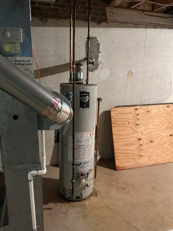 Responded to no hot water complaint affecting entire residence. Upon arrival, accessed basement utility area through rear entrance as requested. Inspected tank-style water heater and associated copper supply lines. Diagnosed failed heating element preventing proper water temperature. Replaced defective heating element, tested thermostat functionality, and verified proper electrical connections. Restored hot water service to all fixtures throughout the home. Unit tested and confirmed operational before departure.