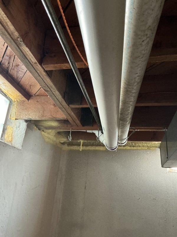 Conducted comprehensive assessment of existing 20-year-old furnace system located in basement mechanical room for replacement estimate. Documented current HVAC installation including air handler unit, associated ductwork configuration with galvanized metal supply runs along exposed ceiling joists, and existing infrastructure layout. Evaluated equipment accessibility, electrical connections, gas line routing, condensate drainage system, and existing duct connections to determine optimal replacement specifications and installation requirements for new high-efficiency furnace system.