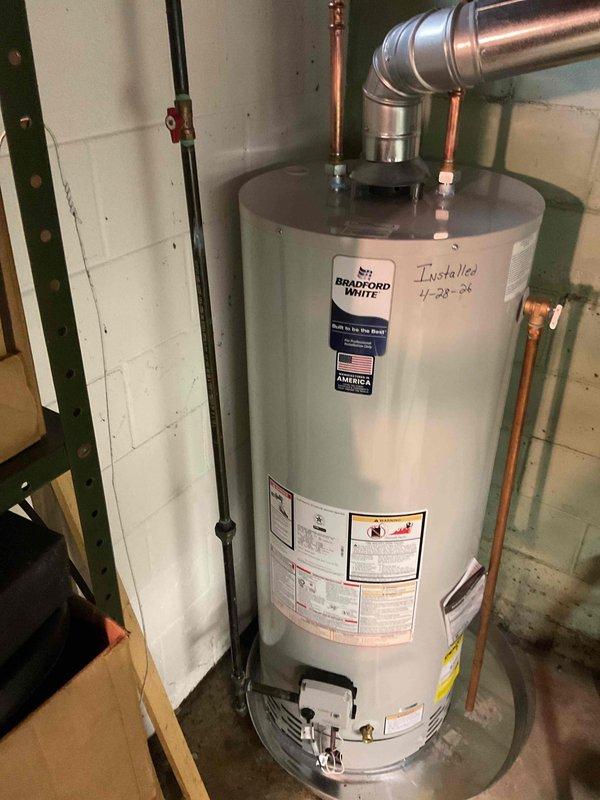 Replaced leaking Bradford White water heater, originally installed in 2006, with new 50-gallon tanked unit including installation of drain pan with drain line for leak protection. Completed all necessary plumbing connections using copper piping and installed proper venting through galvanized flue pipe in accordance with manufacturer specifications and local code requirements.