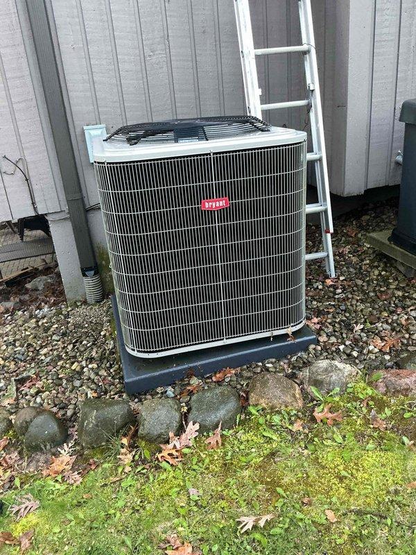 Completed comprehensive Gold AC inspection on a 5-year-old residential air conditioning system with outdoor condensing unit and basement-located air handler. Performed thorough visual examination of exterior condenser unit, verifying proper installation on equipment pad, checking refrigerant line connections, and inspecting electrical conduit routing. Documented equipment condition with photographs showing unit properly positioned on gravel base with adequate clearance for airflow and service access. Verified manufacturer specifications and confirmed system operational readiness for cooling season.