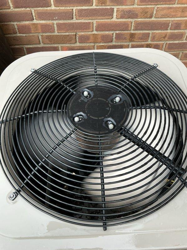 Completed comprehensive Gold AC Inspection on a 10-year-old residential cooling system with air handler located in basement and condenser unit positioned exterior against brick foundation. Performed thorough multi-point inspection including verification of operational status, visual assessment of outdoor condenser unit with fan assembly and protective grille showing normal wear consistent with age, and evaluation of basement-mounted equipment including Bryant humidifier control system with proper humidity settings calibrated for seasonal temperature ranges. All components inspected and found to be functioning as designed with no immediate service needs identified at time of inspection.