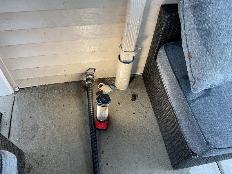 Responded to ongoing sump pump drainage issue affecting both basement interior and exterior discharge system in 47-year-old residential property. Inspected exterior discharge line and identified improper drainage configuration with corrugated flexible hose creating potential for water backup and freeze concerns. Relocated and secured exterior discharge piping away from foundation to ensure proper water evacuation and prevent recirculation into sump basin. Verified pump operation and discharge flow to exterior termination point. System now functioning correctly with improved drainage path to protect foundation and prevent basement water intrusion.