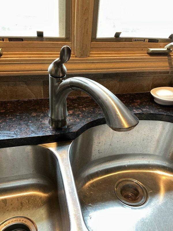 Responded to plumbing service call for leaking sump pump connection in basement and dripping kitchen faucet. Inspected sump pump basin and discharge piping, identifying leak at connection point where PVC discharge pipe meets pump outlet. Tightened connection and verified proper seal to eliminate water seepage. Examined kitchen faucet with single-handle design and high-arc spout, finding worn cartridge causing persistent drip from spout. Replaced faulty cartridge and tested operation to confirm drip was eliminated and proper water flow restored. Verified no additional plumbing issues present throughout remainder of home. All repairs completed successfully with systems operating as intended.