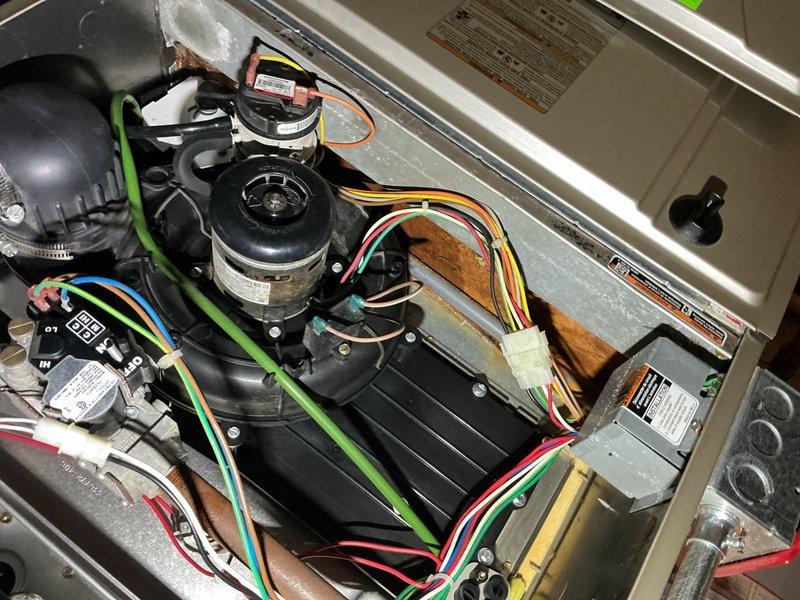 Completed comprehensive tune-up and maintenance inspection on 10-year-old residential air conditioning system located in backyard. Performed full system evaluation including inspection of compressor, condenser coil, evaporator assembly, blower motors, electrical connections, and refrigerant lines. Observed moderate corrosion on copper refrigerant piping and general age-related wear on components. Checked all electrical connections, motor operations, capacitors, and control modules for proper function. Verified system operational parameters, airflow, and overall performance. All components operating within normal specifications with no immediate repairs required. Documented system condition with photographs showing internal components, wiring harnesses, dual blower motors, control modules, and refrigerant line condition for maintenance records. System operational and ready for continued service.
