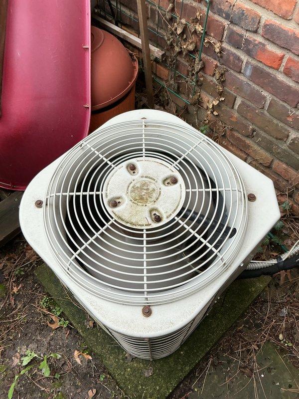 Completed comprehensive Gold AC Inspection on two 30-year-old air conditioning systems, one located in basement and one in attic. Performed thorough evaluation of both units including inspection of condenser coils, fan assemblies, electrical connections, refrigerant levels, and overall system operation. Exterior condenser unit showed significant accumulation of organic debris, moss growth on surrounding surfaces, and weathering on protective grills with visible corrosion on mounting hardware. Documented condition of heat exchanger components and finned coil surfaces which displayed dirt and dust buildup consistent with age and environmental exposure. Verified operational status of both systems and provided recommendations for ongoing maintenance given the advanced age of equipment. All findings photographically documented for customer records.