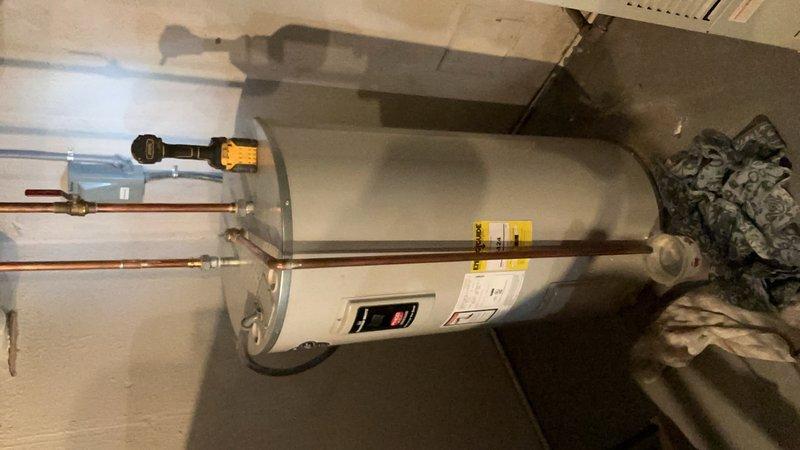 Responded to report of leaking vent tube on 4-year-old residential water heater. Upon inspection, identified leak originating from temperature and pressure relief valve discharge pipe connection. Verified unit was producing hot water normally with no other operational issues. Inspected TPR valve, discharge piping, and associated copper connections at top of tank. Tightened fittings and verified proper valve operation and seating to resolve leak condition.