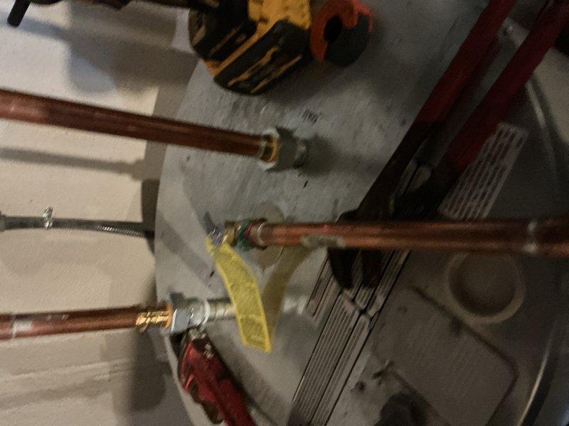 Responded to report of leaking vent tube on 4-year-old residential water heater. Upon inspection, identified leak originating from temperature and pressure relief valve discharge pipe connection. Verified unit was producing hot water normally with no other operational issues. Inspected TPR valve, discharge piping, and associated copper connections at top of tank. Tightened fittings and verified proper valve operation and seating to resolve leak condition.