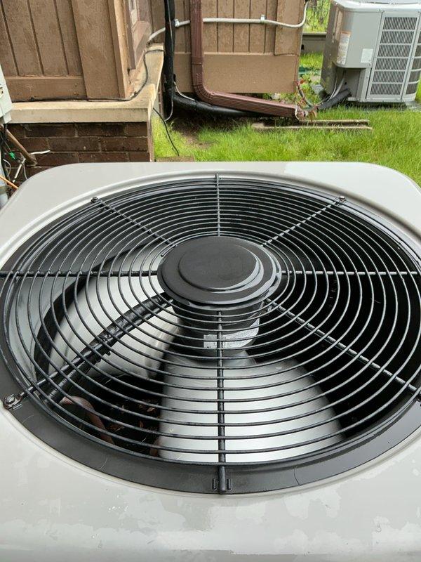Completed comprehensive Gold AC inspection on 7-year-old single-unit air conditioning system with air handler located in basement. Performed thorough evaluation of outdoor condenser unit, confirming proper fan operation, intact wire guard assembly, and clean exterior surfaces with no visible damage or deterioration. Inspected refrigerant lines, condensate drain system with Diversitech condensate pump installation, and electrical connections. System confirmed operational and functioning within normal parameters at time of inspection.