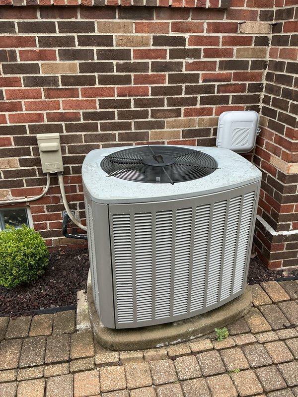 Completed comprehensive Gold AC inspection on 16-year-old residential cooling system with basement-located air handler and outdoor condensing unit. Performed full system evaluation including inspection of indoor evaporator coil assembly, Enviracare Elite humidifier integration with ductwork, and outdoor condenser unit positioned on concrete pad against brick exterior. Verified proper operation of all components, checked electrical connections at disconnect box and outdoor receptacle, confirmed adequate clearance around condenser unit, and assessed overall system condition. Unit currently operating as designed with all safety controls functioning properly.