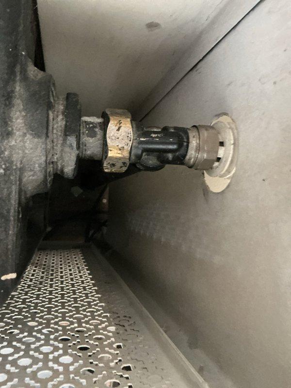 Responded to service call for hydronic heating system with one radiator not heating properly. Upon inspection, found that supply piping to radiator was getting hot but heat was not transferring to radiator body, indicating potential air lock or valve obstruction. Examined radiator valve assembly and shaft mechanism, noting significant corrosion and wear on internal components. Diagnosed issue as failed or stuck radiator valve preventing proper water circulation through the unit. Recommended valve replacement or rebuild to restore proper heating function to affected radiator.