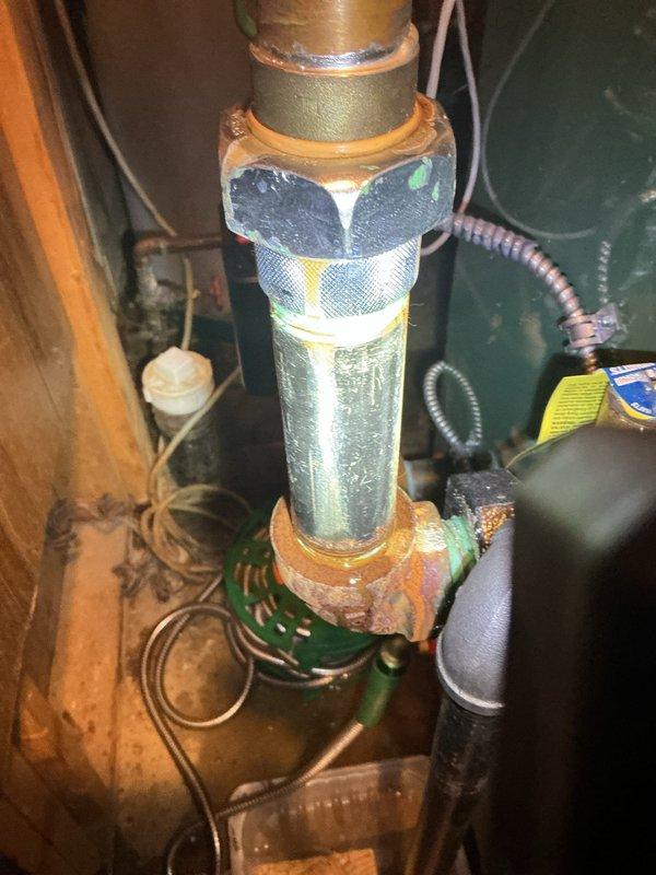 Responded to leak complaint on recently installed hot water boiler system located in lower level. Upon inspection, identified two primary issues: loose 1-1/4" union connection at circulator pump requiring proper torque with appropriately sized wrench, and insufficient solder joint at top of circulator pump. Photographic documentation captured moisture accumulation on copper piping and brass fittings, confirming active leak points. Tightened accessible union connection; however, soldering materials were not available on service vehicle at time of visit. Noted that 1-1/4" union and soldering supplies are available at shop for completion of repairs. Equipment is approximately four months old, showing signs of condensation and minor corrosion on brass components due to ongoing leak condition. Additional service visit required to complete solder joint repair at circulator pump connection.