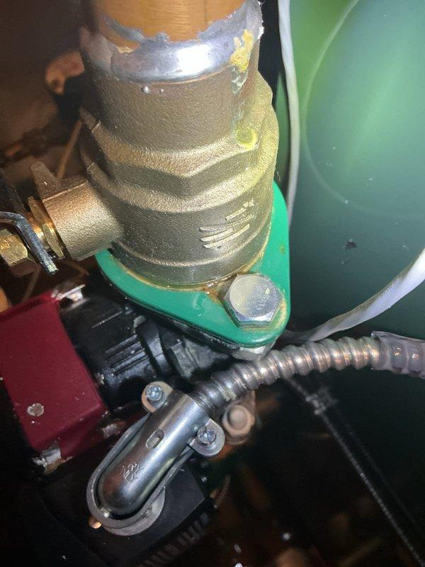 Responded to leak complaint on recently installed hot water boiler system located in lower level. Upon inspection, identified two primary issues: loose 1-1/4" union connection at circulator pump requiring proper torque with appropriately sized wrench, and insufficient solder joint at top of circulator pump. Photographic documentation captured moisture accumulation on copper piping and brass fittings, confirming active leak points. Tightened accessible union connection; however, soldering materials were not available on service vehicle at time of visit. Noted that 1-1/4" union and soldering supplies are available at shop for completion of repairs. Equipment is approximately four months old, showing signs of condensation and minor corrosion on brass components due to ongoing leak condition. Additional service visit required to complete solder joint repair at circulator pump connection.