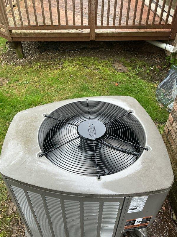 Completed prepaid maintenance inspection on a two-year-old residential HVAC system consisting of multiple units with air handler located in basement. Performed routine maintenance on outdoor condenser unit positioned on concrete pad in backyard, inspecting fan operation, protective grille, louvered panels, and overall unit condition. All equipment confirmed operational at time of service, with system functioning as designed.