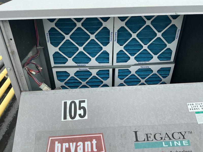 Performed scheduled commercial HVAC maintenance on single Bryant Legacy Line rooftop unit (RTU). Inspected and verified proper installation of five blue pleated air filters in housing unit, confirmed filters in good condition with clean media. Documented equipment specifications, verified gas line connections, and assessed overall unit operation on flat roof installation. All system components found in satisfactory working condition during routine maintenance inspection.