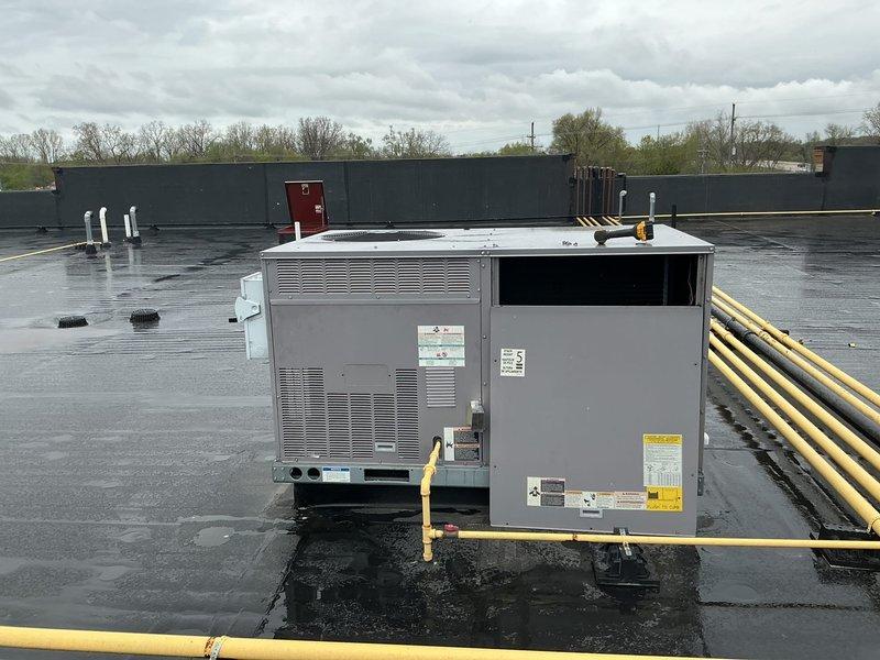 Performed scheduled commercial HVAC maintenance on single Bryant Legacy Line rooftop unit (RTU). Inspected and verified proper installation of five blue pleated air filters in housing unit, confirmed filters in good condition with clean media. Documented equipment specifications, verified gas line connections, and assessed overall unit operation on flat roof installation. All system components found in satisfactory working condition during routine maintenance inspection.