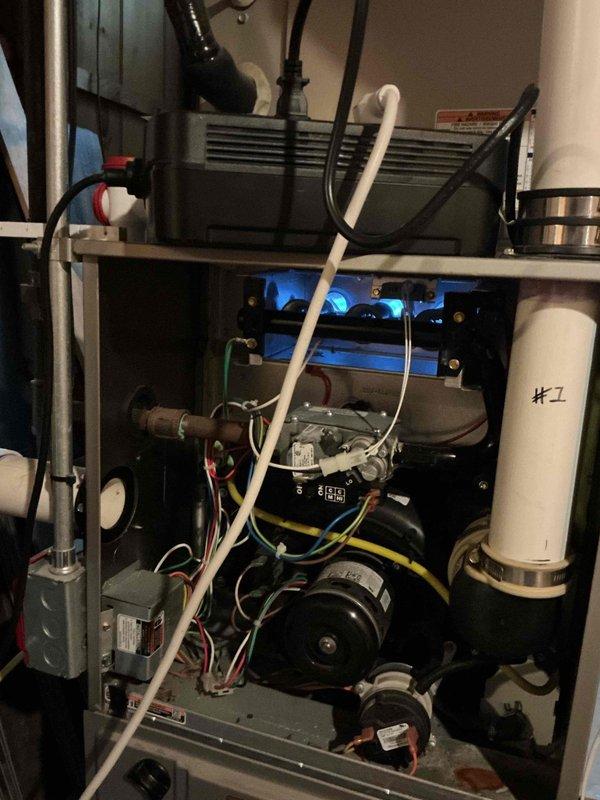 Responded to no-heat call for residential furnace displaying blinking red error code on burner emergency switch. Upon arrival, performed diagnostic inspection of gas-fired forced air unit located in basement. Identified faulty flame sensor causing improper flame detection and system lockout. Removed and cleaned flame sensor rod to restore proper flame sensing capability. Verified gas valve operation, igniter function, and burner assembly performance. Cycled system through multiple heating cycles to confirm proper ignition sequence and sustained burner operation. Tested all safety controls including limit switches and pressure switches. Verified proper venting through PVC exhaust system and confirmed adequate combustion air supply. System restored to full operational status with normal heating output and all error codes cleared.