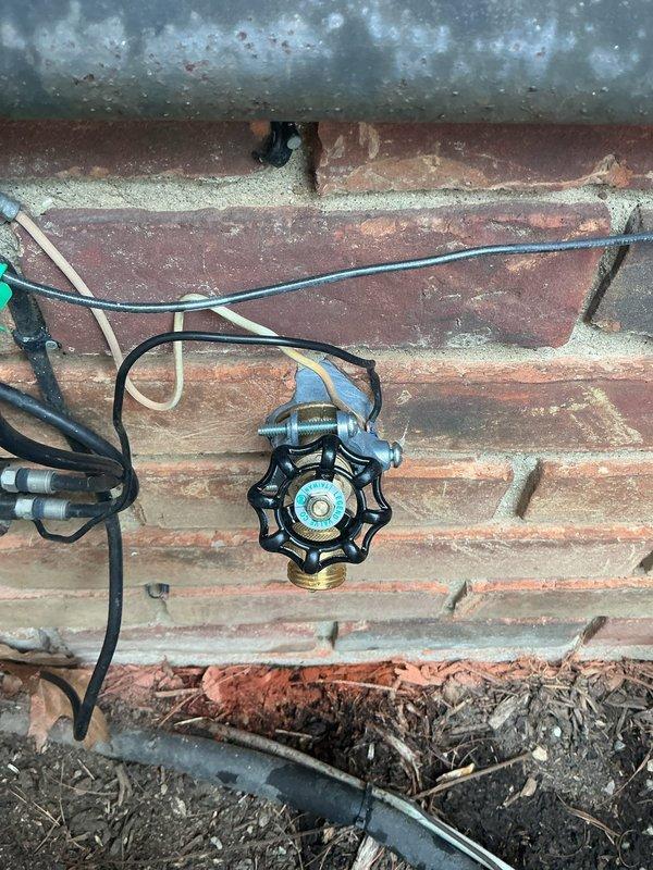 Replaced exterior hose bib (frost-free sillcock) mounted on brick foundation due to worn valve mechanism and deteriorated internal components. Removed old fixture, verified proper drainage slope, and installed new brass frost-free valve with anti-siphon protection to prevent freeze damage and ensure code compliance.