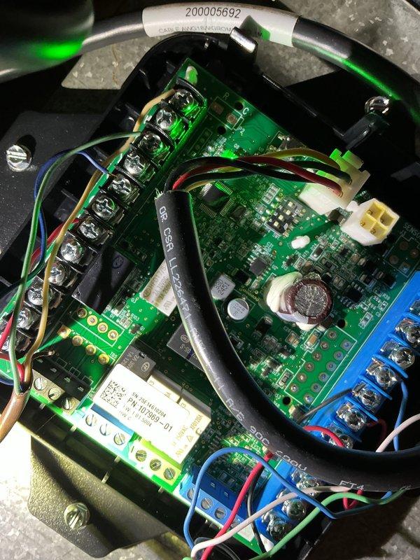 Responded to service call for 10-month-old AC unit in basement with no heating or cooling capability, though blower motor was operational. Performed diagnostic evaluation and identified malfunctioning control board as root cause of system failure. Accessed control board assembly housed in black plastic enclosure, inspecting circuit boards, wiring connections, and terminal blocks. Verified thermostat communication and settings showing 72-degree setpoint on Emerson unit. Replaced defective mitigation board, ensuring all wire connections were properly secured to terminal blocks and system controls were functioning correctly. Tested system operation to confirm restoration of heating and cooling functions.