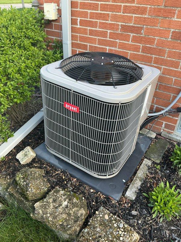 Completed comprehensive Gold AC Inspection on 8-year-old residential air conditioning system with outdoor condenser unit and basement-located air handler. Performed full system evaluation including visual inspection of condenser unit positioned on composite pad against exterior brick wall, verified proper clearances around unit with adequate airflow access, inspected electrical connections and refrigerant lines, and assessed overall equipment condition. Confirmed system operational status and documented equipment specifications for maintenance records.