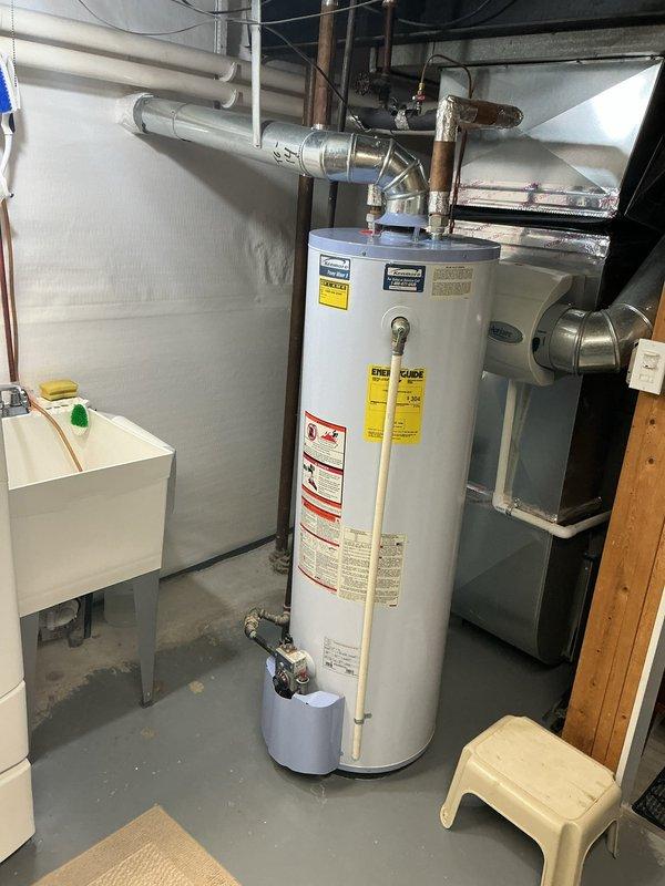 Completed comprehensive Gold AC Inspection on 8-year-old residential air conditioning system with outdoor condenser unit and basement-located air handler. Performed full system evaluation including visual inspection of condenser unit positioned on composite pad against exterior brick wall, verified proper clearances around unit with adequate airflow access, inspected electrical connections and refrigerant lines, and assessed overall equipment condition. Confirmed system operational status and documented equipment specifications for maintenance records.