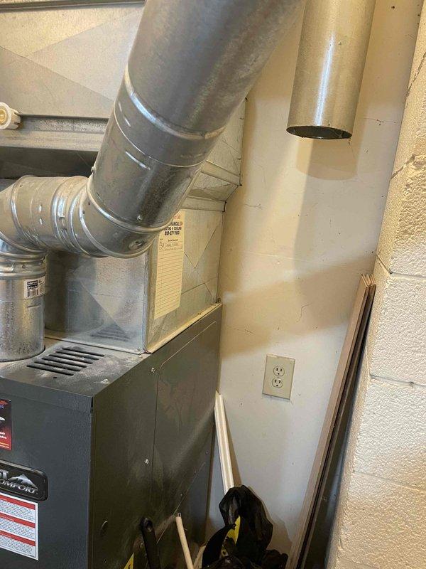 Completed full estimate and site assessment for new central air conditioning system installation in residence with no existing central air infrastructure. Evaluated existing Fieldcrest furnace unit and utility room configuration to determine optimal placement for new AC condenser, evaporator coil, and associated ductwork modifications. Documented current HVAC setup including existing forced-air heating system with metallic ductwork, electrical service availability, and mechanical room space constraints to develop comprehensive installation proposal for complete central cooling system integration.